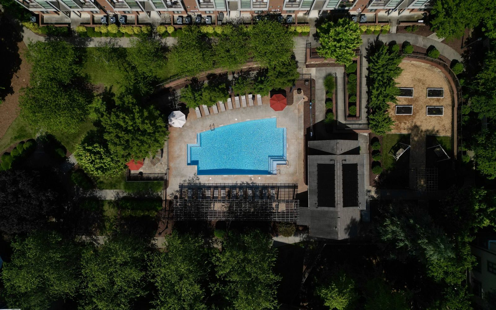Aerial view of the Chapel Hill North Apartments community in Pineville, NC showing the outdoor pool and surrounding townhome buildings